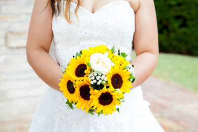 Midsection of woman holding bouquet