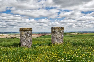 Hay bales on field against sky