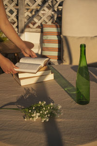 High angle view of woman reading book on table