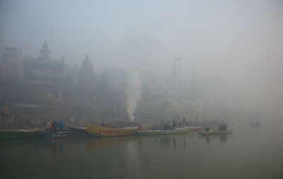 Boats in river with buildings in background