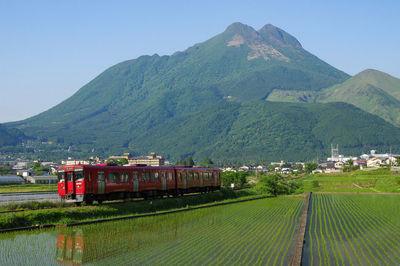 Clear blue sky, mt. yufu, rice paddy and kiha 200 local train