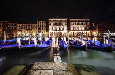 Boats moored against buildings