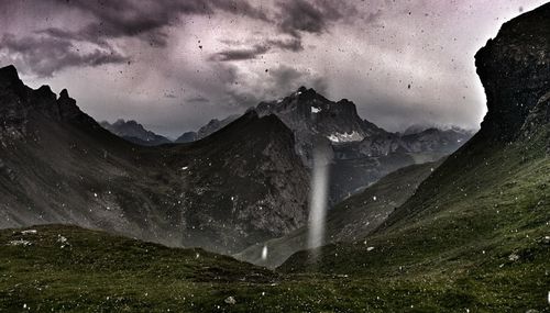 Scenic view of mountains against sky at night