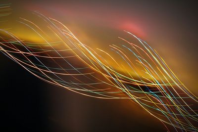 Low angle view of light trails against sky during sunset