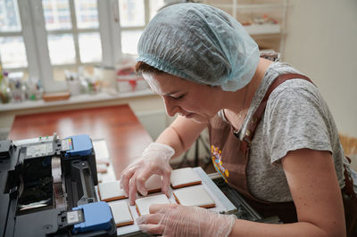 Female chef working at kitchen