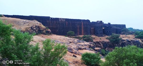 Panoramic view of rocks and trees against clear sky