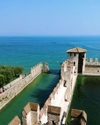 High angle view of sea against clear blue sky