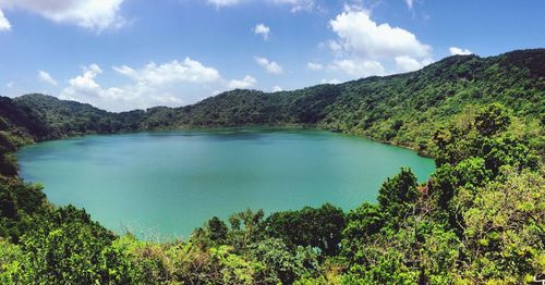 Scenic view of lake by trees against sky