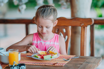 Cute girl having breakfast-