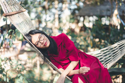 Smiling woman relaxing on hammock