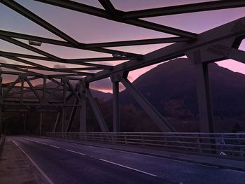 Low angle view of illuminated bridge against sky at night