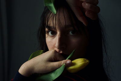 Close-up portrait of woman holding fruit