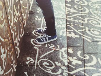 Low section of person standing on wall