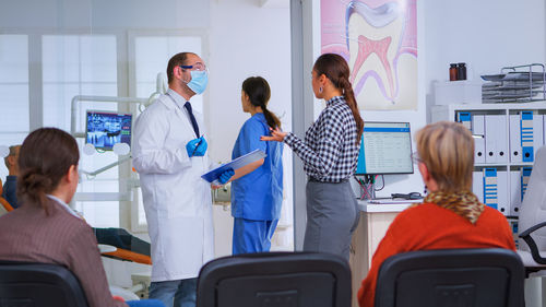 Female doctor examining patient in office