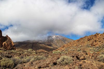 Smoke emitting from volcanic mountain against sky