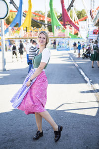 Portrait of woman standing on street at event