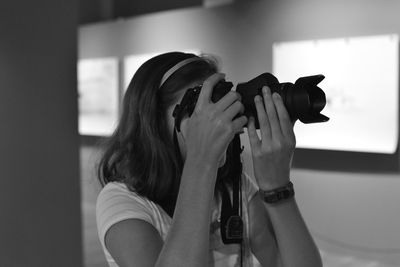 Close-up of girl photographing with camera in museum