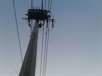 Low angle view of ski lift against clear sky