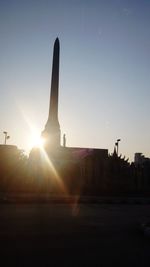 Silhouette built structure against clear sky during sunset