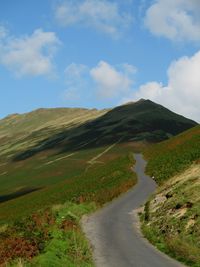 Scenic view of mountain road against sky