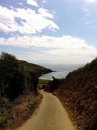 Scenic view of road against cloudy sky