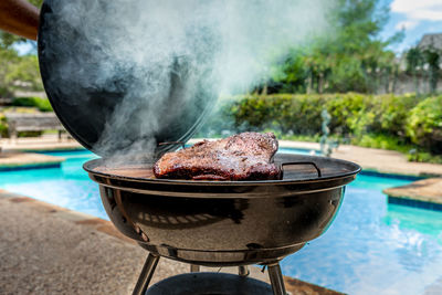 Close-up of meat on barbecue grill in yard