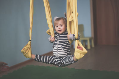 Rear view of woman swinging at playground