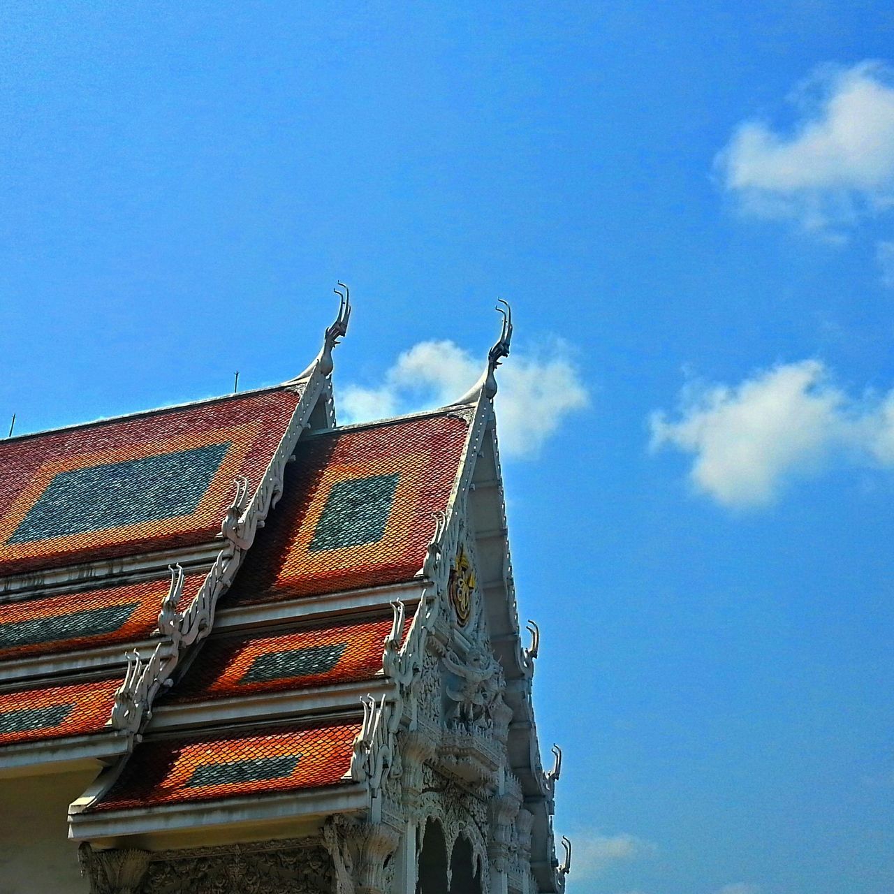 architecture, built structure, building exterior, low angle view, religion, place of worship, spirituality, roof, sky, clear sky, church, blue, high section, day, outdoors, no people, tower, cross, temple - building