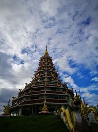 Low angle view of temple against cloudy sky