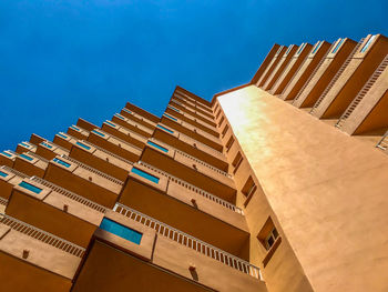 Low angle view of modern building against clear blue sky