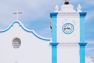 Low angle view of clock tower against building