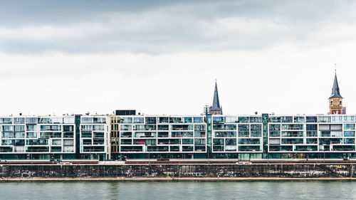 View of buildings against cloudy sky