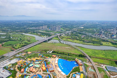 High angle view of river amidst buildings in city against sky