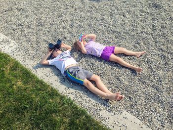 High angle view of women lying down on land