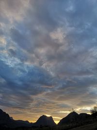 Low angle view of silhouette mountains against sky during sunset