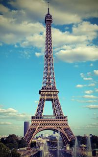 Eiffel tower in paris with white clouds in the sky and a vintage antique effect 