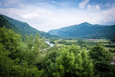 Scenic view of valley and mountains against sky