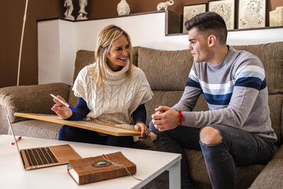 Young couple sitting on table