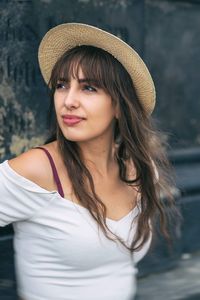 Portrait of beautiful young woman in hat