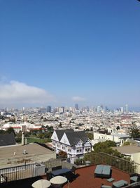 High angle view of buildings against blue sky