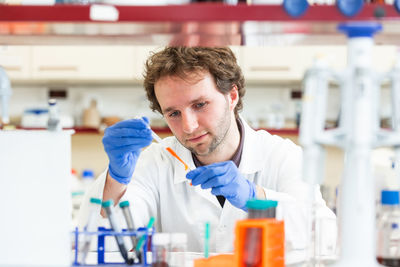 Portrait of young man standing in laboratory