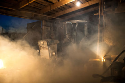 Interior of illuminated machine at night