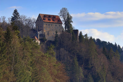 Medieval castle in the woodlands on the top of a hill