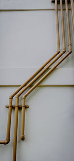 Close-up of pipe against white wall