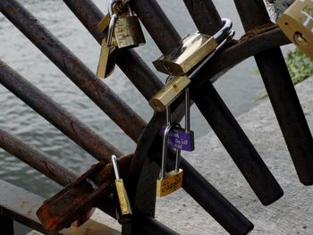 Close-up of padlocks hanging on railing