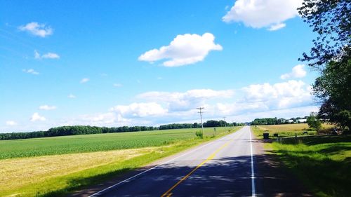 Road by landscape against sky