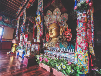 Low angle view of buddha statue against building