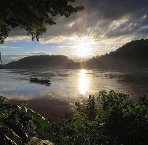 Scenic view of lake against sky at sunset