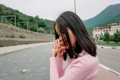 Portrait of woman standing on road
