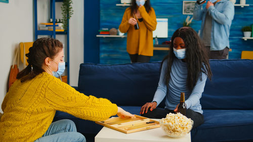 Young woman sitting on table